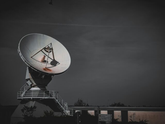 a large satellite dish sitting on top of a metal platform