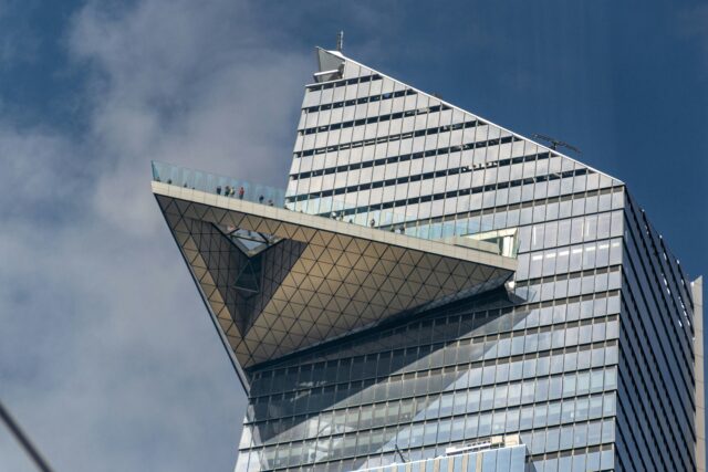 a tall building with a bird on the roof