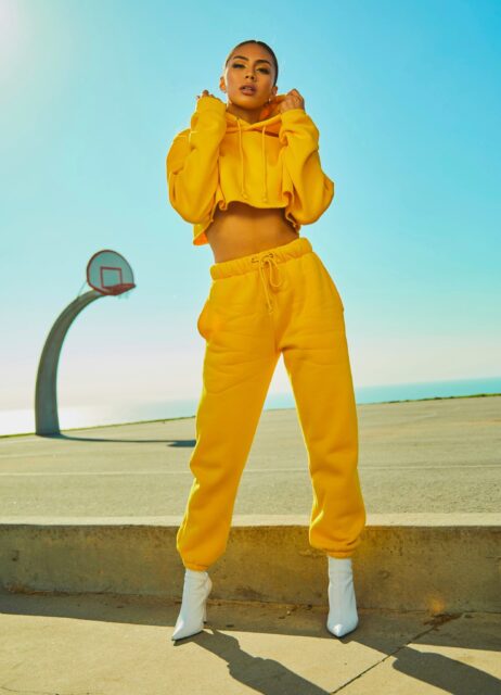 woman in yellow tracksuit standing on basketball court side